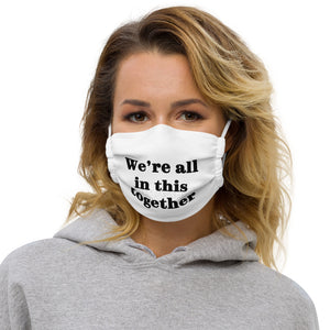 White face mask with the sentence 'We're all in this together'